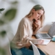 Woman planning at a laptop with coffee while comparing business plan software