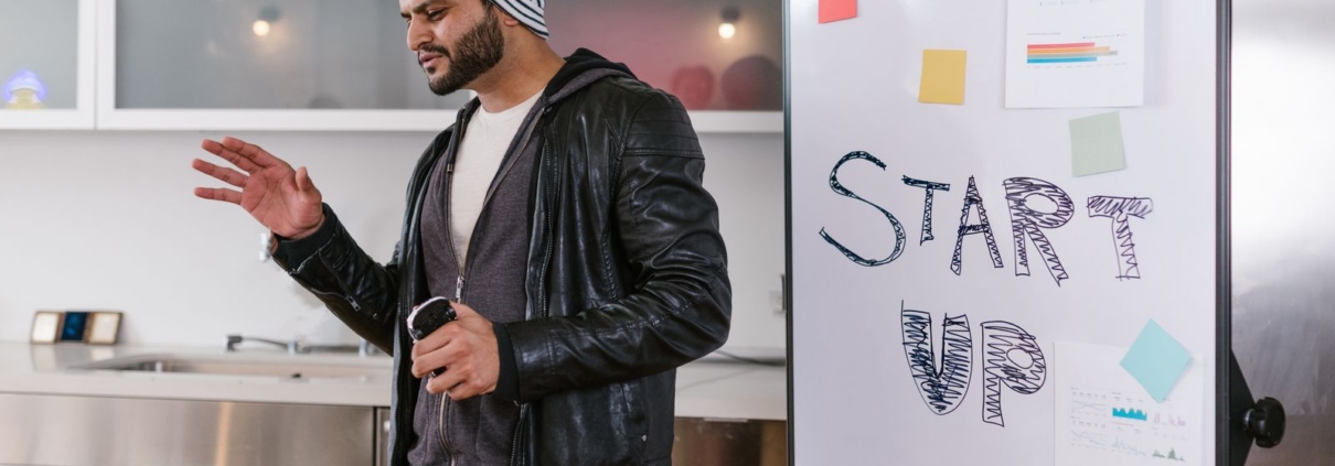 Entrepreneur presenting a start-up plan on a whiteboard while preparing for government funding