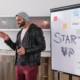Entrepreneur presenting a start-up plan on a whiteboard while preparing for government funding